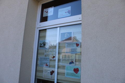 Zdjęcie prezentuje wystawę na oknach Powiatowej Biblioteki Publicznej, która pokazuje, jak znani pisarze definiują słowo miłość i co piszą o tym najważniejszym na świeci uczuciu.