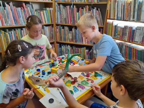 Zdjęcie prezentuje wakacyjne warsztaty kreatywności zorganizowane przez  KOKPiT – Bibliotekę Publiczną w Kazimierzu Dolnym dla dzieci w wieku szkolnym. 